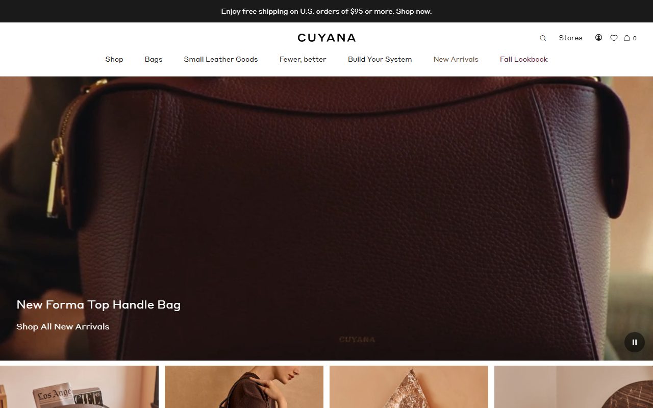 Cuyana官网首页截屏，顶部黑条Enjoy free shipping on U.S. orders of $95 or more，居中字标CUYANA，导航含Shop/Bags/Small Leather Goods/Fewer, better/Build Your System/New Arrivals/Fall Lookbook，hero为深棕色荔枝纹皮革包特写，标题New Forma Top Handle Bag与Shop All New Arrivals链接