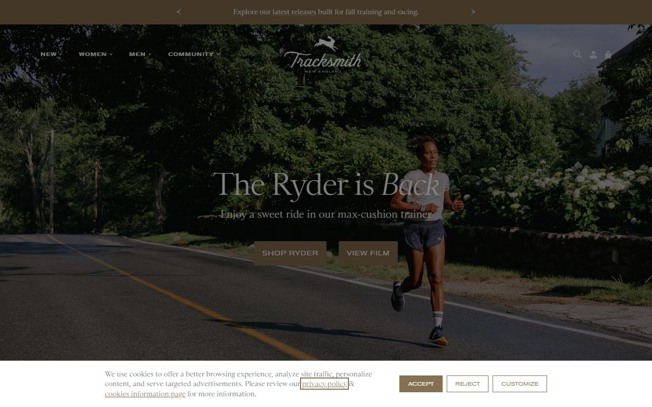 Tracksmith官网首页截屏，顶部公告条Explore our latest releases built for fall training and racing，导航含NEW/WOMEN/MEN/COMMUNITY，hero为乡间公路跑者实拍，标题The Ryder is Back，双按钮SHOP RYDER与VIEW FILM